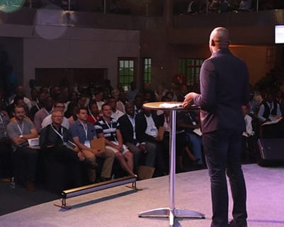 local pastor host site speaking to the audience during the Summit